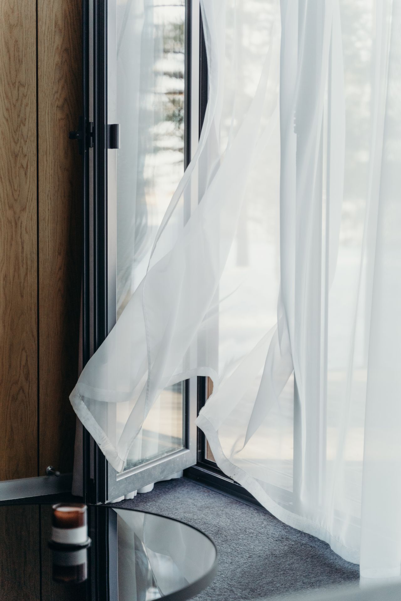 Sliding screen door off its track with curtain moving